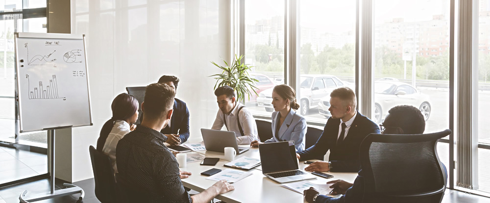 Group of young people in the office at the meeting table