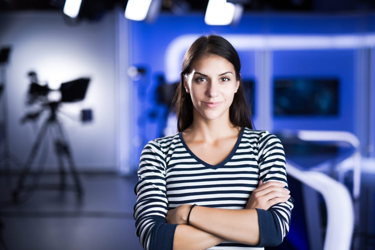 Female TV director at editor in studio. Recording at TV studio with television anchorwoman.