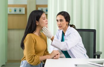 Woman consulting a cosmetic surgeon on beauty procedures for her face, 