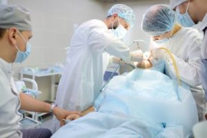 Surgical center medical team during a dental operation.